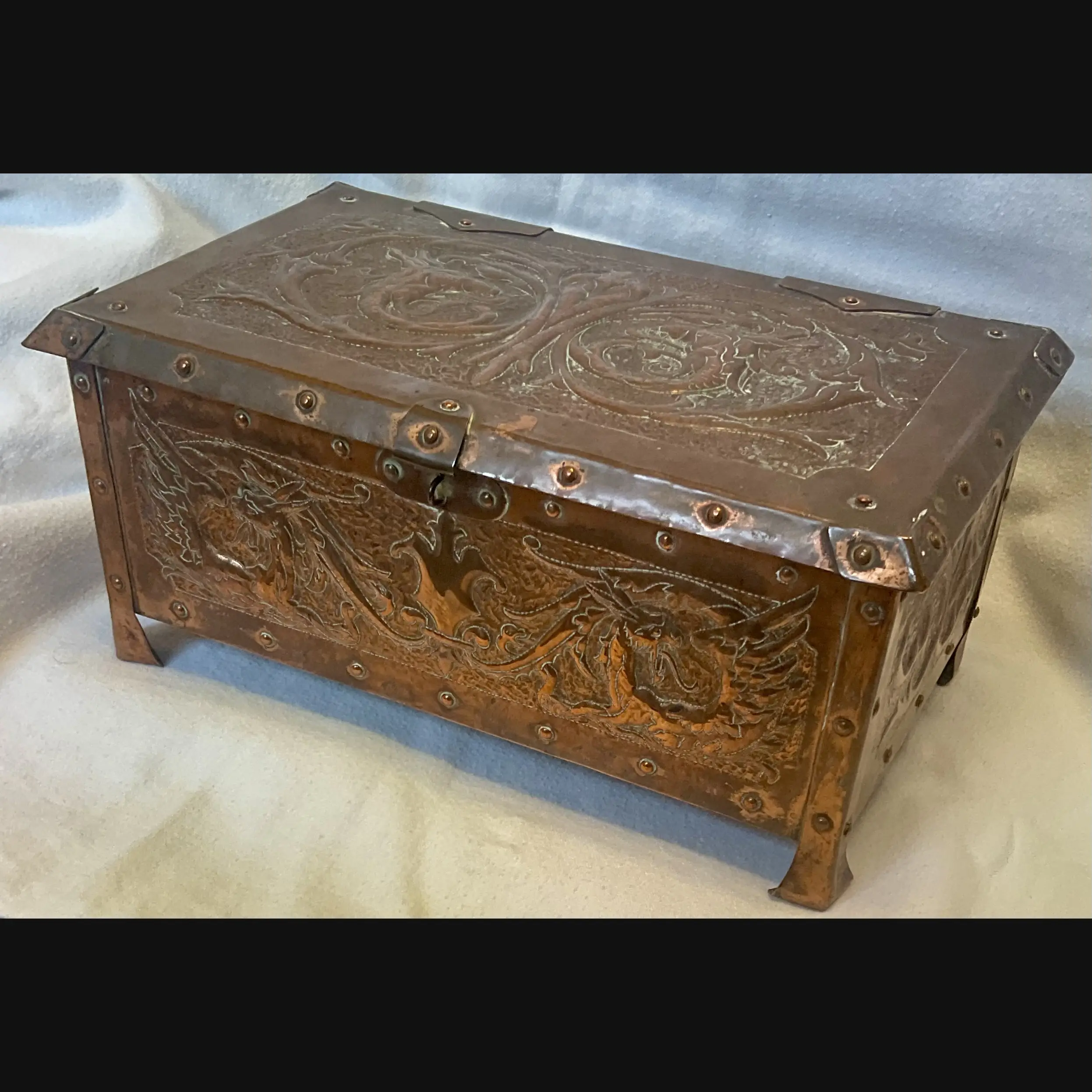 large arts and crafts copper jewel casket with grotesques and griffens velvet lined c1910