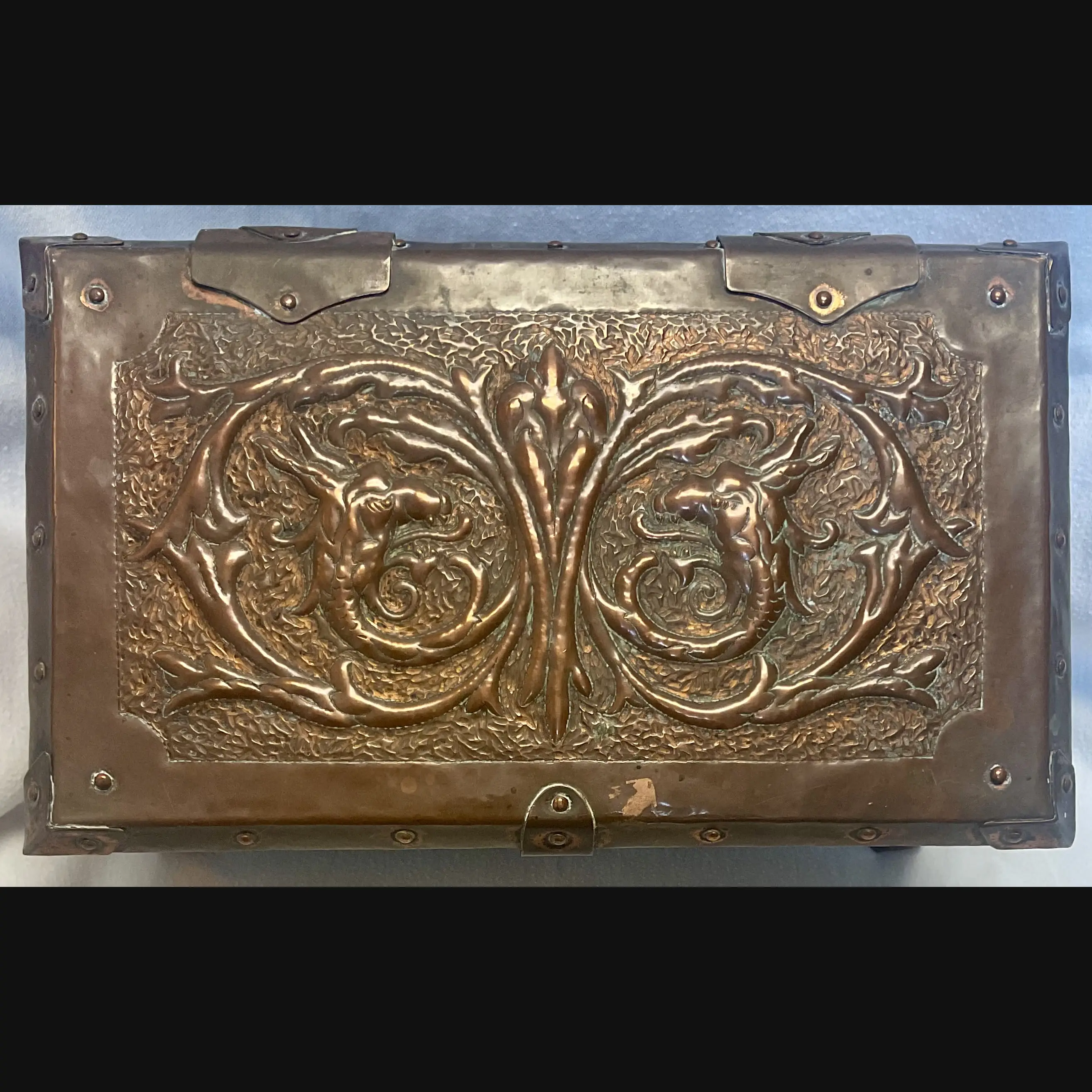 large arts and crafts copper jewel casket with grotesques and griffens velvet lined c1910