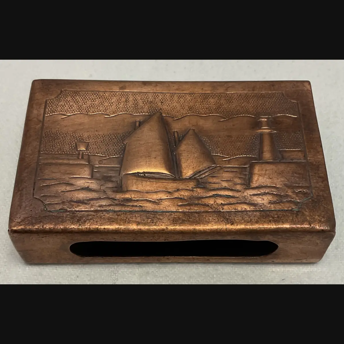 newlyn copper arts and crafts large copper matchbox cover with luggers and lighthouse c1910